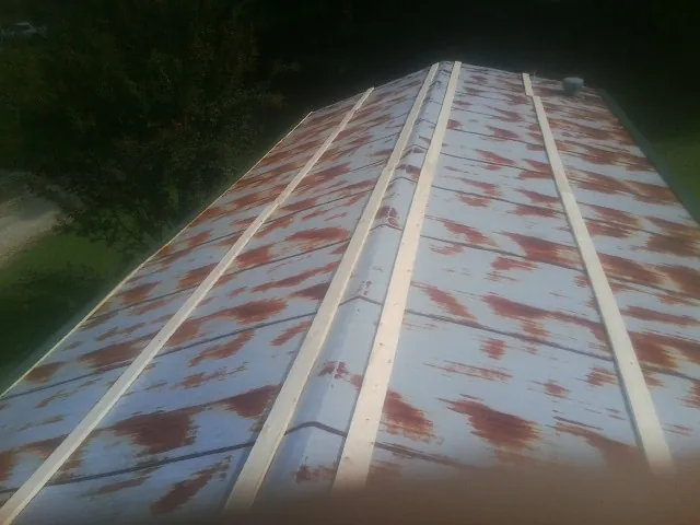Rusted metal roof panels with new wood purlins before replacement — Storm Damage Roof Repair in Ocilla by Roofing Brothers