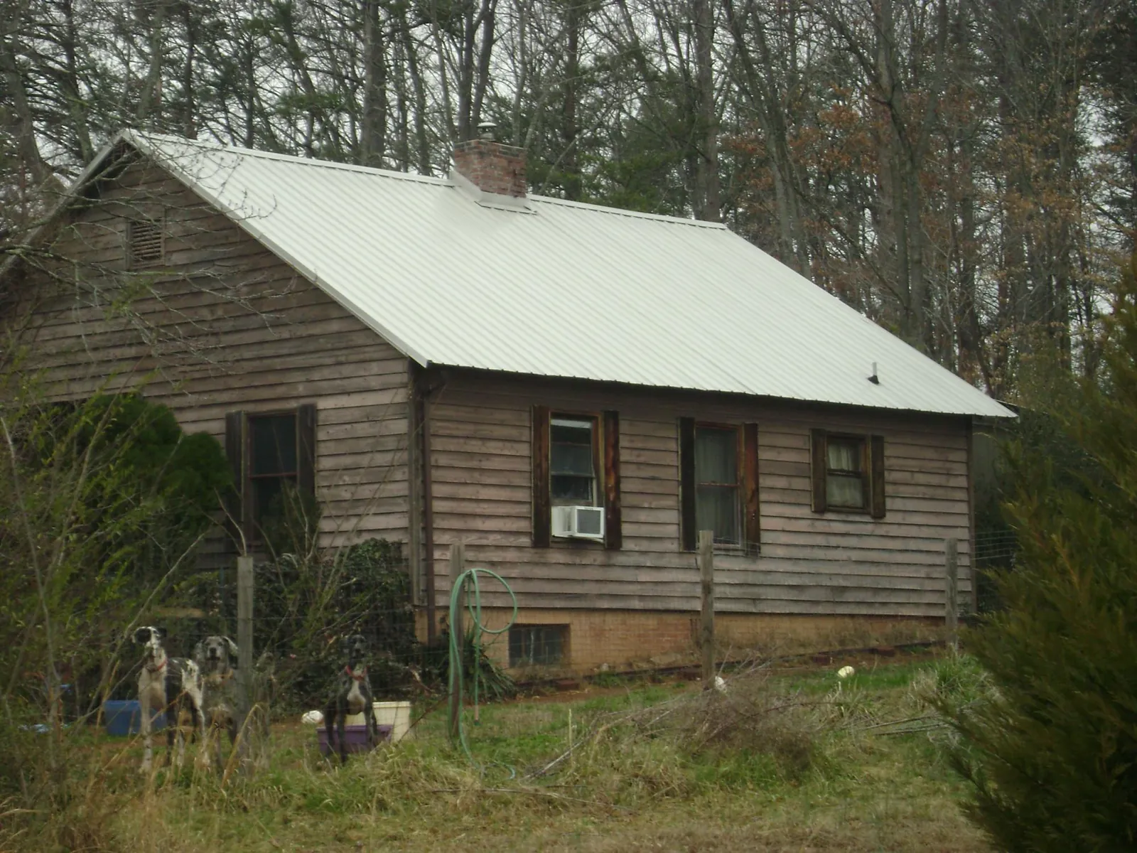 White metal roof on an old wood sided farmhouse, from a Metal Roof Installation job in Ocilla